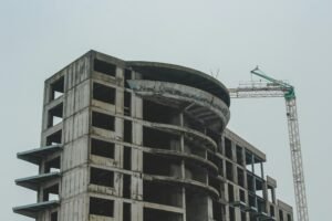 A high-rise building under construction with a crane, showcasing modern architecture in Constanța, Romania.